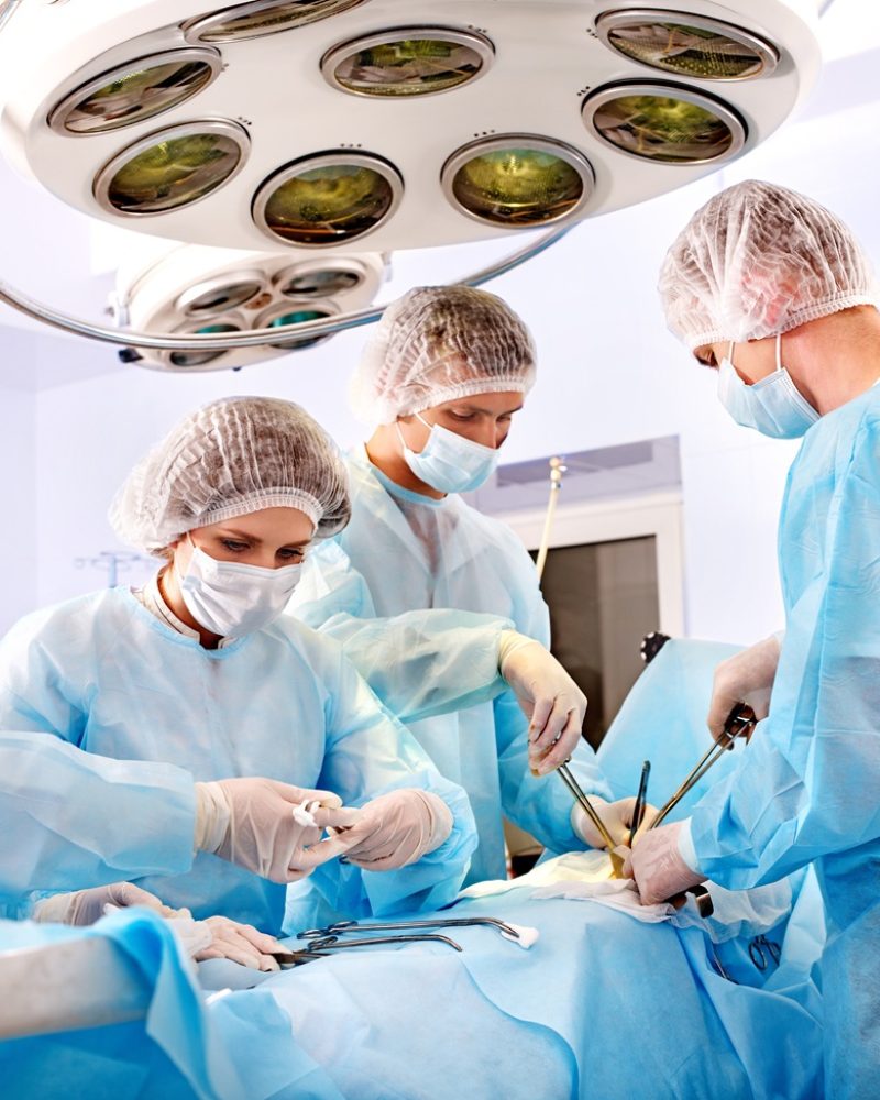 Team surgeon at work in operating room.