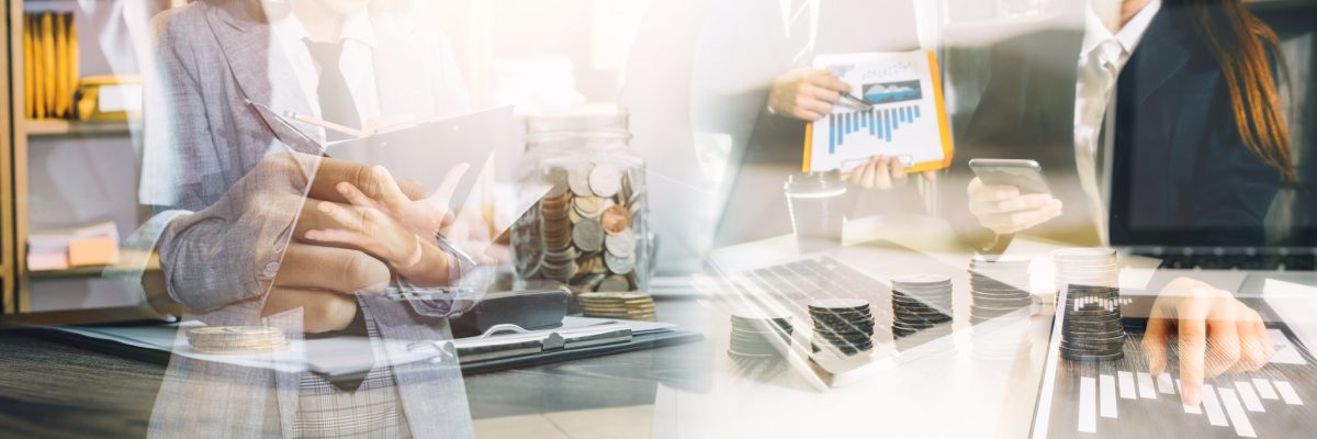 Business team finance or bookkeeper working with a calculator to calculate business data summary report, accountancy document and laptop computer at the office, business meeting concept